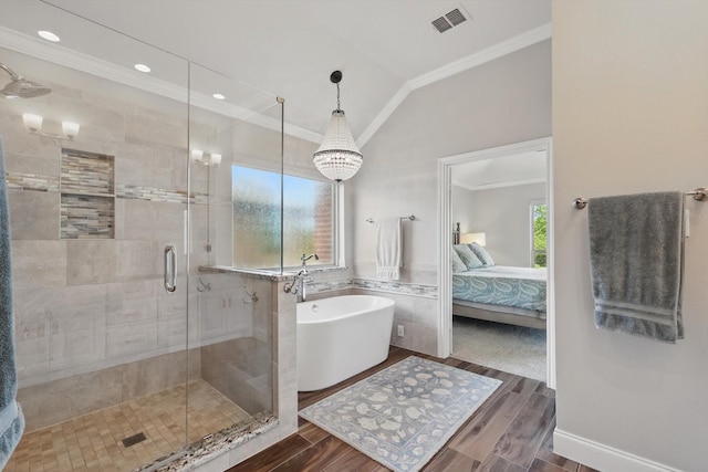528 Layton Dr, Coppell, TX 75019 - ensuite bathroom featuring ornamental molding, a stall shower, a freestanding tub, vaulted ceiling, and wood finished floors