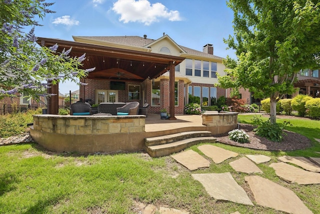 528 Layton Dr, Coppell, TX 75019 - back of house with ceiling fan, a patio area, a chimney, and brick siding