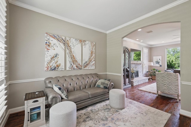 528 Layton Dr, Coppell, TX 75019 - living area with arched walkways, dark wood finished floors, ornamental molding, baseboards, and recessed lighting