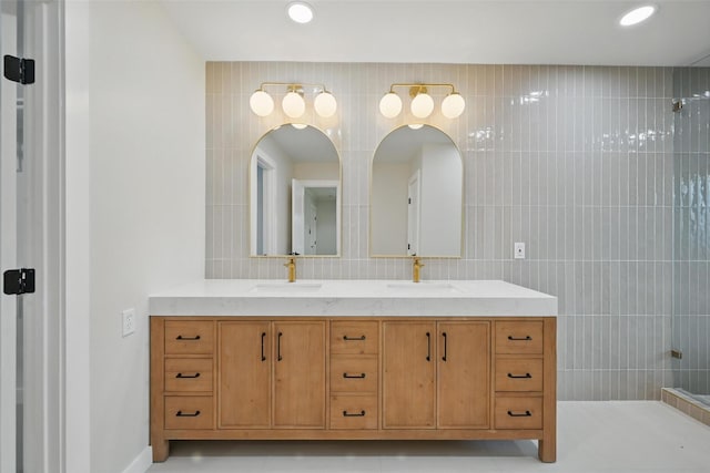 6407 Laurel Valley Rd, Dallas, TX 75248 - bathroom with a tile shower, double vanity, recessed lighting, tile walls, and baseboards