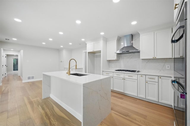 6407 Laurel Valley Rd, Dallas, TX 75248 - kitchen with wall chimney range hood, a sink, light wood-style flooring, white cabinets, and tasteful backsplash