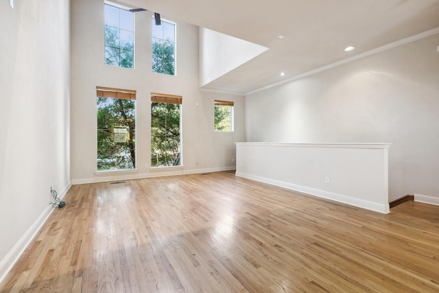 2028 N Haskell Ave, Dallas, TX 75204 - unfurnished living room with light wood-style floors, ornamental molding, baseboards, and recessed lighting