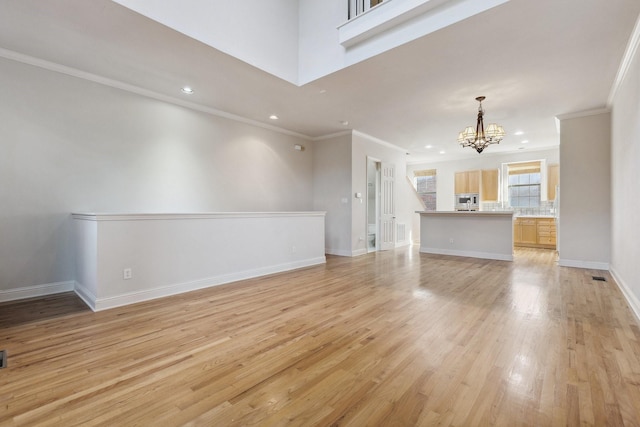 2028 N Haskell Ave, Dallas, TX 75204 - unfurnished living room featuring a chandelier, ornamental molding, light wood finished floors, recessed lighting, and baseboards
