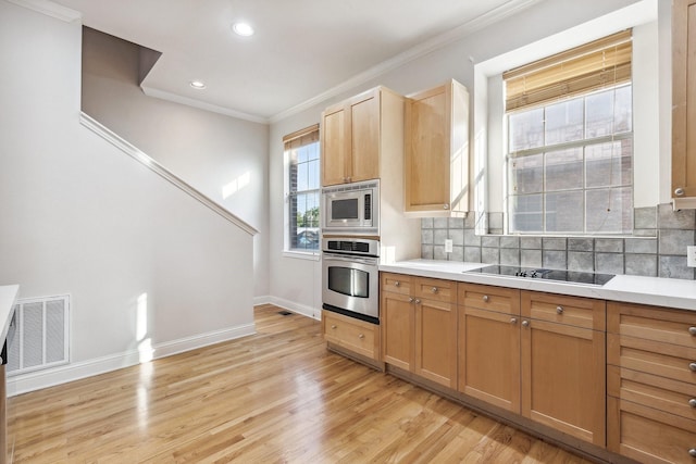 2028 N Haskell Ave, Dallas, TX 75204 - kitchen with appliances with stainless steel finishes, crown molding, light wood finished floors, backsplash, and baseboards