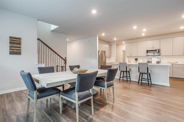 2148 Bellatrix Dr, Haslet, TX 76052 - dining room with stairway, light wood-type flooring, and recessed lighting