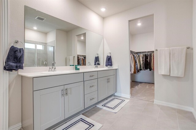 2148 Bellatrix Dr, Haslet, TX 76052 - full bathroom featuring a shower stall, a spacious closet, double vanity, baseboards, and recessed lighting