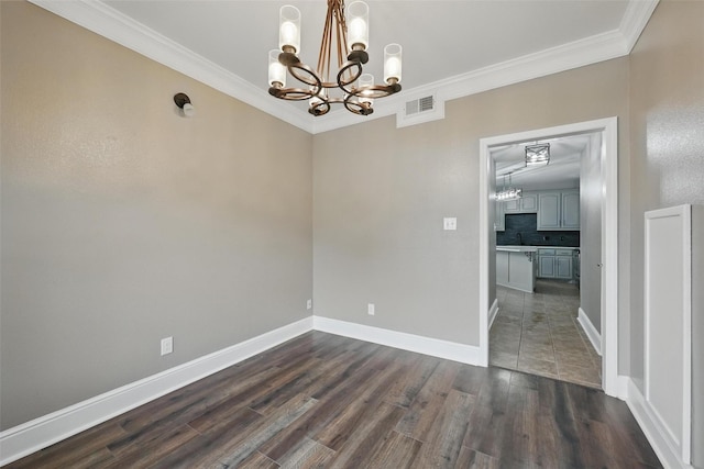 3211 Ruidoso Ln, Mckinney, TX 75070 - spare room featuring a chandelier, crown molding, dark wood-type flooring, and baseboards