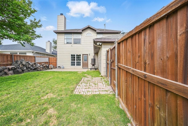 3211 Ruidoso Ln, Mckinney, TX 75070 - back of property featuring a patio area and a chimney