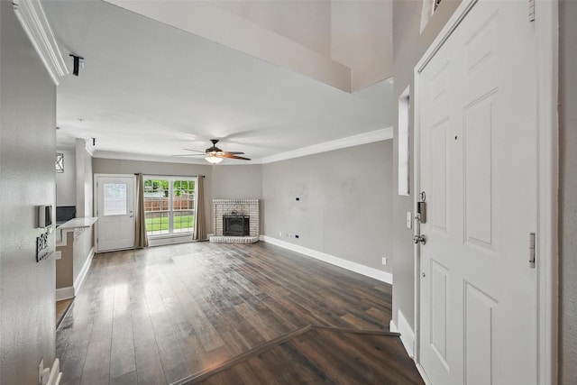 3211 Ruidoso Ln, Mckinney, TX 75070 - unfurnished living room featuring baseboards, a ceiling fan, a fireplace, dark wood finished floors, and crown molding