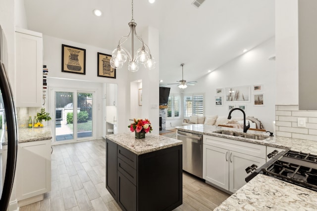 569 Dove Creek Cir, Grapevine, TX 76051 - kitchen featuring stainless steel dishwasher, a sink, high vaulted ceiling, ceiling fan, and tasteful backsplash