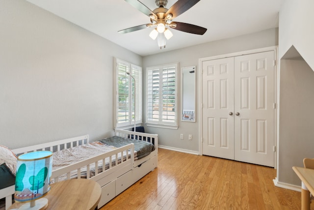 569 Dove Creek Cir, Grapevine, TX 76051 - bedroom with wood finished floors, baseboards, a closet, and a ceiling fan