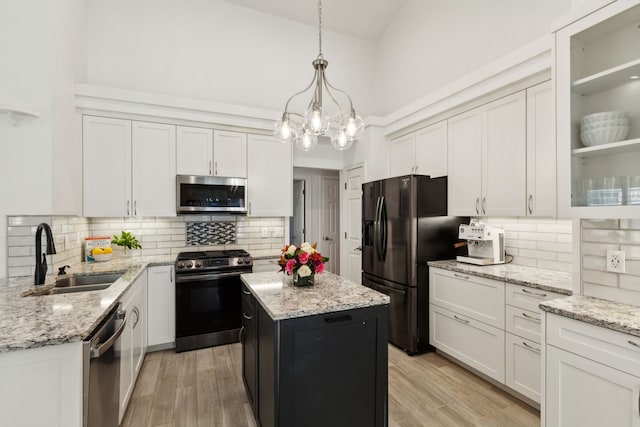 569 Dove Creek Cir, Grapevine, TX 76051 - kitchen with stainless steel appliances, a sink, high vaulted ceiling, backsplash, and white cabinets