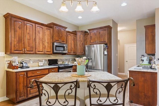 128 Creek Rdg, Waco, TX 76708 - kitchen with stainless steel appliances, a breakfast bar area, decorative backsplash, baseboards, and recessed lighting
