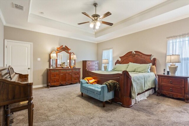 128 Creek Rdg, Waco, TX 76708 - bedroom featuring a tray ceiling, multiple windows, light carpet, crown molding, and ceiling fan