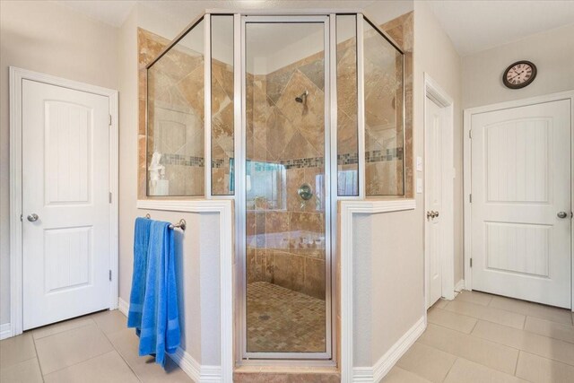128 Creek Rdg, Waco, TX 76708 - full bathroom featuring tile patterned floors, a stall shower, and baseboards