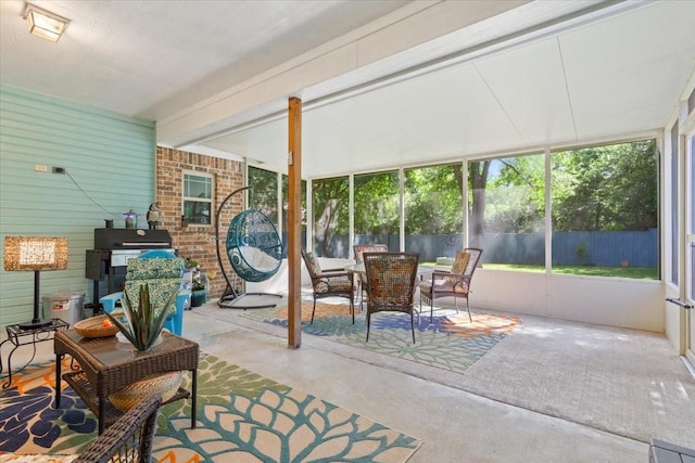 128 Creek Rdg, Waco, TX 76708 - sunroom / solarium featuring plenty of natural light, a wood stove, and outdoor dining space