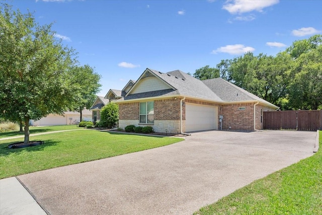 128 Creek Rdg, Waco, TX 76708 - view of front of home with a garage, driveway, brick siding, roof with shingles, and stone siding