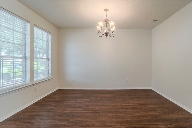 4617 Barnhill Ln, Fort Worth, TX 76135 - empty room featuring a chandelier, dark wood finished floors, and baseboards