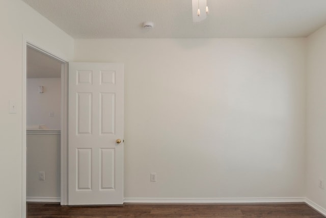4617 Barnhill Ln, Fort Worth, TX 76135 - unfurnished room featuring dark wood-style flooring, a smoke detector, and baseboards