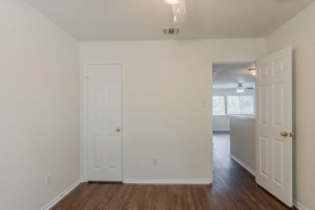 4617 Barnhill Ln, Fort Worth, TX 76135 - empty room featuring a ceiling fan, dark wood finished floors, a textured ceiling, and baseboards