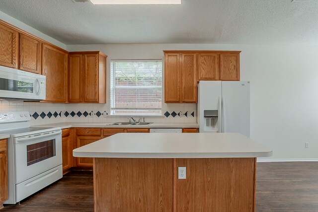4617 Barnhill Ln, Fort Worth, TX 76135 - kitchen with white appliances, a sink, dark wood finished floors, decorative backsplash, and a textured ceiling