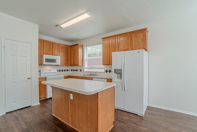 4617 Barnhill Ln, Fort Worth, TX 76135 - kitchen with white appliances, dark wood-style floors, a sink, a center island, and light countertops