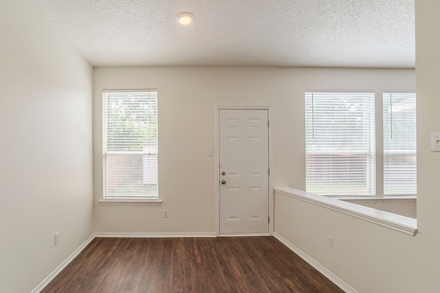 4617 Barnhill Ln, Fort Worth, TX 76135 - entryway with dark wood finished floors, baseboards, and a textured ceiling