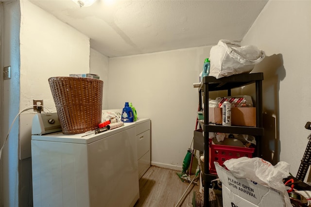 6058 Golden Gate Dr, Dallas, TX 75241 - laundry room featuring washing machine and dryer, light wood finished floors, and baseboards