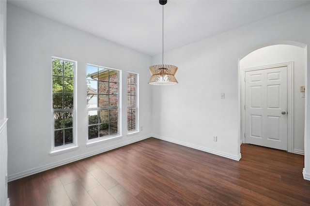 2668 Silver Hill Dr, Fort Worth, TX 76131 - unfurnished dining area with baseboards, dark wood-style floors, and arched walkways