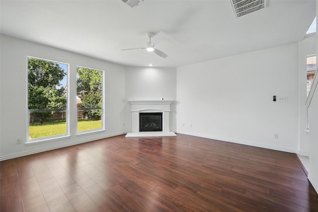 2668 Silver Hill Dr, Fort Worth, TX 76131 - unfurnished living room with a ceiling fan, dark wood-type flooring, a glass covered fireplace, and baseboards