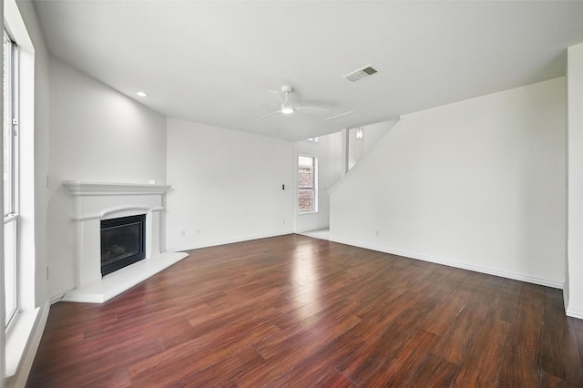 2668 Silver Hill Dr, Fort Worth, TX 76131 - unfurnished living room featuring wood finished floors, a glass covered fireplace, ceiling fan, baseboards, and recessed lighting