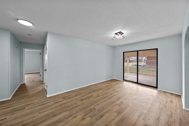 4306 Frog Dr, Killeen, TX 76542 - spare room with wood finished floors, a textured ceiling, and baseboards