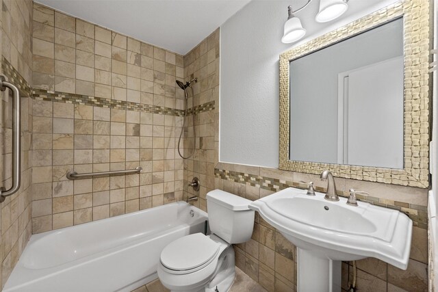 4306 Frog Dr, Killeen, TX 76542 - full bath with washtub / shower combination, tile walls, toilet, a sink, and wainscoting