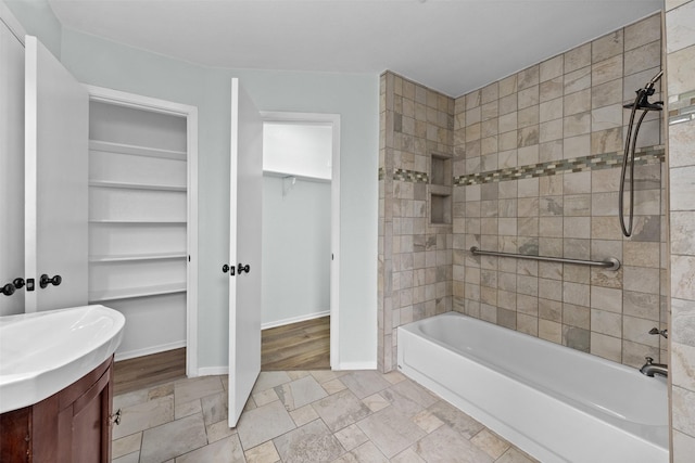 4306 Frog Dr, Killeen, TX 76542 - bathroom with washtub / shower combination, vanity, a spacious closet, and baseboards