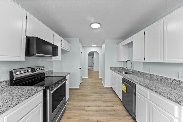 4306 Frog Dr, Killeen, TX 76542 - kitchen featuring electric stove, dishwasher, a sink, arched walkways, and light wood finished floors