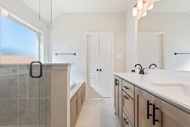 514 Geyser Trl, Waco, TX 76657 - bathroom featuring a garden tub, a shower stall, double vanity, tile patterned floors, and vaulted ceiling