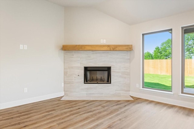 514 Geyser Trl, Waco, TX 76657 - unfurnished living room featuring wood finished floors, a fireplace, baseboards, and lofted ceiling