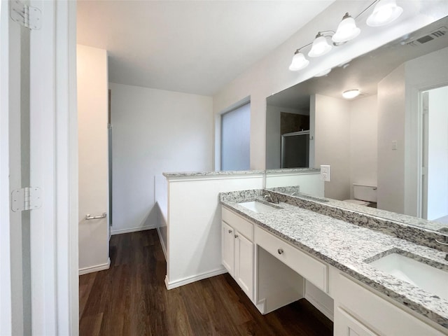 603 Jamie Ln, Mansfield, TX 76063 - bathroom with wood finished floors, double vanity, a stall shower, and baseboards