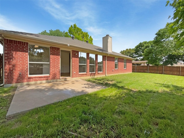 603 Jamie Ln, Mansfield, TX 76063 - back of house featuring a chimney, brick siding, and a patio area