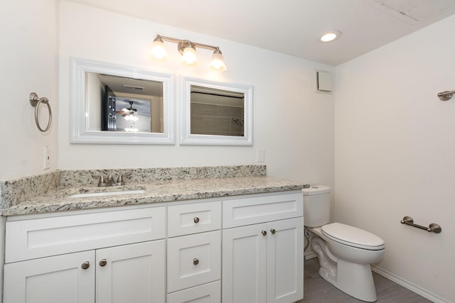 8750 Park Ln Unit 151, Dallas, TX 75231 - bathroom with vanity, toilet, ceiling fan, and baseboards