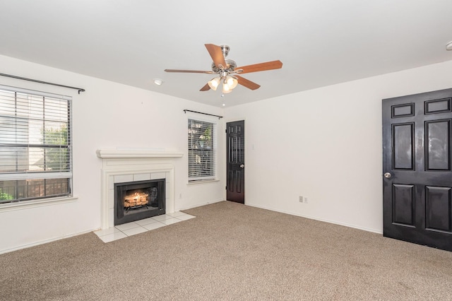 8750 Park Ln Unit 151, Dallas, TX 75231 - unfurnished living room featuring carpet, ceiling fan, a tiled fireplace, and baseboards