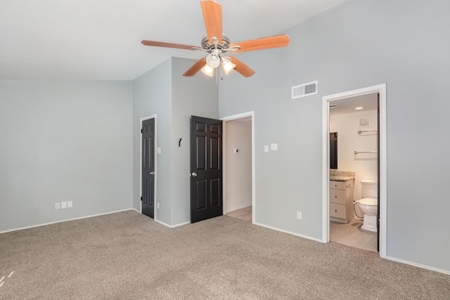 8750 Park Ln Unit 151, Dallas, TX 75231 - unfurnished bedroom featuring light colored carpet, high vaulted ceiling, baseboards, connected bathroom, and ceiling fan