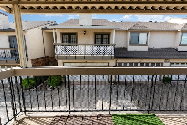 8750 Park Ln Unit 151, Dallas, TX 75231 - view of front of home featuring stucco siding, a balcony, fence, and a chimney