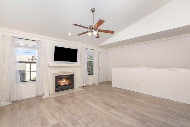 8750 Park Ln Unit 151, Dallas, TX 75231 - unfurnished living room featuring lofted ceiling, a tiled fireplace, ceiling fan, light wood-type flooring, and recessed lighting