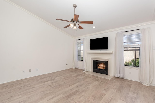 8750 Park Ln Unit 151, Dallas, TX 75231 - unfurnished living room with ornamental molding, light wood-type flooring, a ceiling fan, a tile fireplace, and recessed lighting