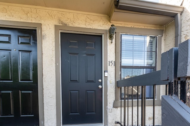 8750 Park Ln Unit 151, Dallas, TX 75231 - doorway to property with stucco siding
