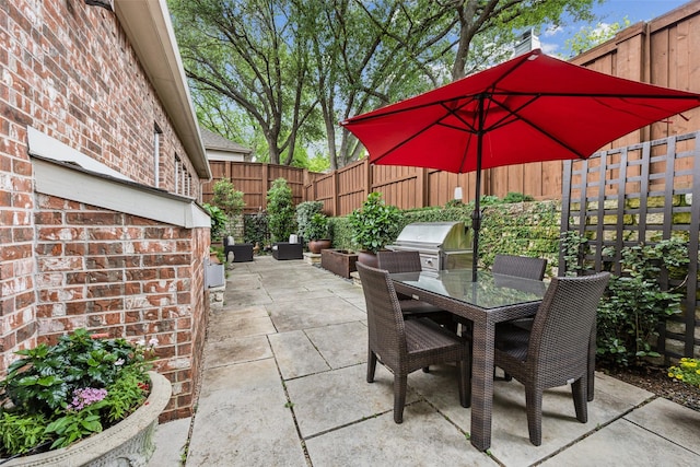 7904 Briar Brook Ct, Dallas, TX 75218 - view of patio / terrace with a grill, outdoor dining space, a fenced backyard, and exterior kitchen
