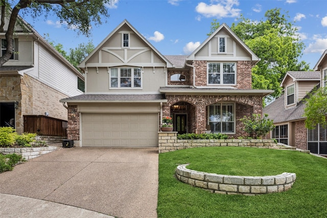 7904 Briar Brook Ct, Dallas, TX 75218 - tudor home with driveway, a front yard, an attached garage, brick siding, and stucco siding