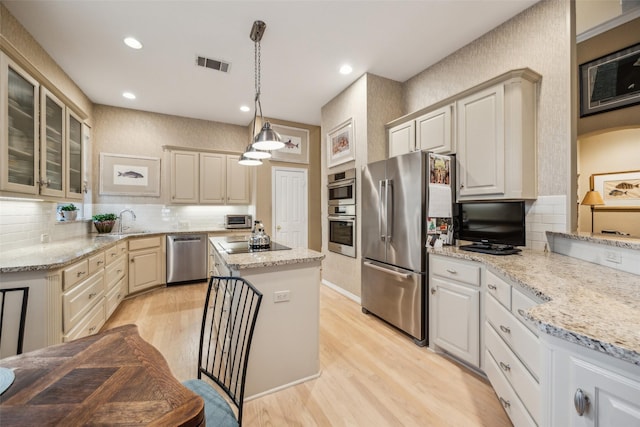 7904 Briar Brook Ct, Dallas, TX 75218 - kitchen with stainless steel appliances, light wood-style floors, tasteful backsplash, a sink, and glass insert cabinets