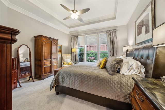 7904 Briar Brook Ct, Dallas, TX 75218 - bedroom with light colored carpet, a raised ceiling, ornamental molding, and ceiling fan